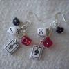 Earrings made of small beads shaped like a playing card and  red, white and black dice on a silver chain and silver ear wires. These were inspired by my sister-in-law. 11.00