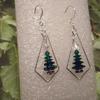 Earrings of Swarovski crystal beads layered in a tree shape, and surrounded by a sterling silver frame. They have a small crystal bead star on top, a crystal beaded base of deep red, and are on french ear wires. 30.00